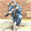 Dale Feese with the air rifle he built and the deer he harvested with it.