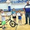 Partners in Education winners for September were Zander Ackley, at left with bike and Alexis Mayberry and Zavery Smith with Kindles. Superintendent David Probasco presented the awards. They were sponsored by Landes Oil, Landes Propane and Dustman Digging.