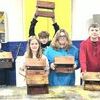 From left to right; Morgan Marrs, Braxton Hursman, Kamran Marrs, Marshall Holtzclaw, Bailey Neeley, Kaydan Jackson and Evan Malott.
	The 8th grade Industrial Tech class at Tri County just concluded their unit on woodworking by making and staining bird feeders. The next unit will focus on principles of electricity and circuits. The instructors are Boyd Harrison and Curtis May.