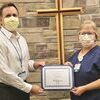 Kathi Tolly receives the Wright Memorial Hospital Employee of the Quarter Award for second quarter 2022 from Steve Schieber, CEO.