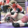 Jaiden Rainey, in red, attempts to pin an opponent.